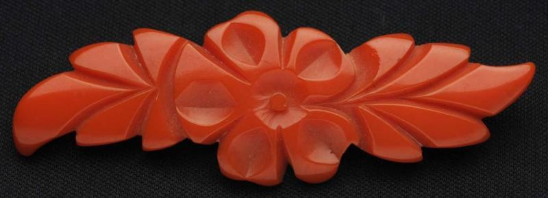 Appraisal: Bakelite Orange Floral Pin Description Deeply carved Condition Excellent Size