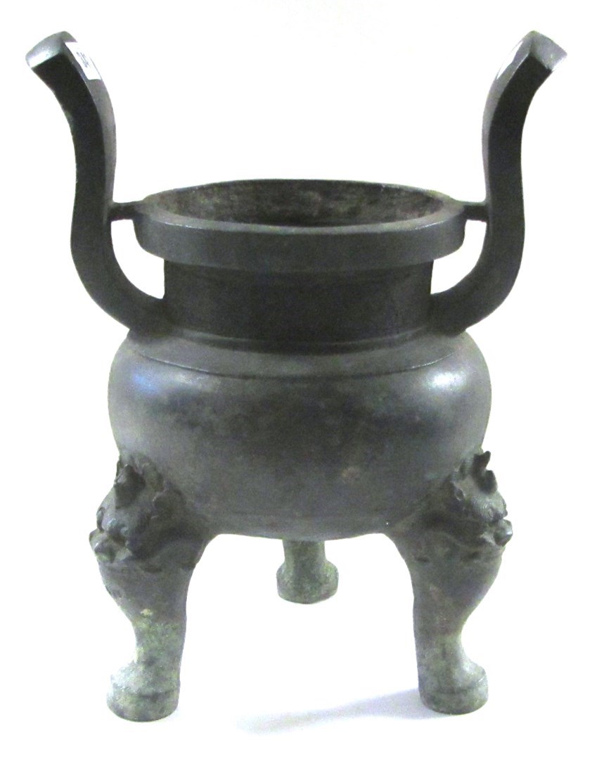 Appraisal: A Chinese bronze tripod censer ding bulbous body set with