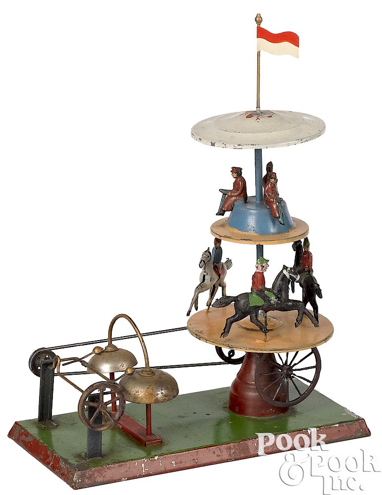 Appraisal: German two-tier painted tin steam toy carousel German two-tier painted