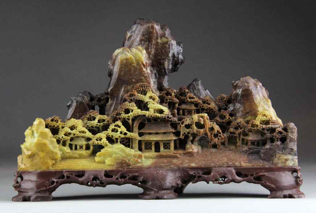 Appraisal: Chinese Qing Carved Soapstone MountainDepicting a village with ancient pine