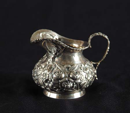 Appraisal: STERLING REPOUSSE CREAMER Short squat creamer with decorative flower and