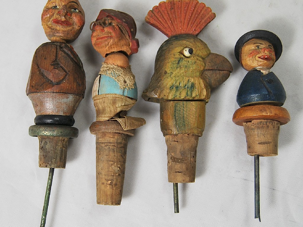 Appraisal: Four German carved wood novelty bottle-stops