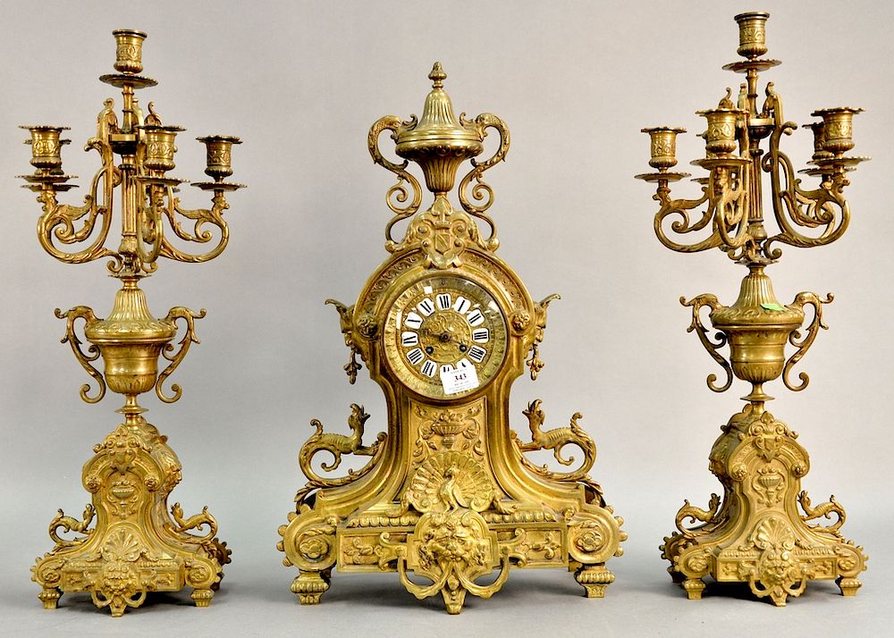 Appraisal: Three piece brass clock set including large clock having figural