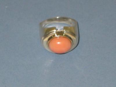 Appraisal: AN ANGEL SKIN CORAL RING the oval cabochon set into