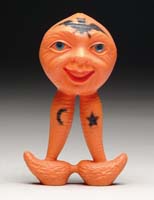 Appraisal: RARE CELLULOID DOUBLE-FACED VEGETABLE-MAN RATTLE Orange rattle with black highlights