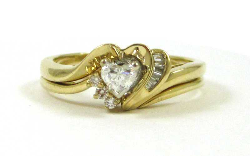 Appraisal: DIAMOND AND FOURTEEN KARAT GOLD WEDDING SET The engagement ring