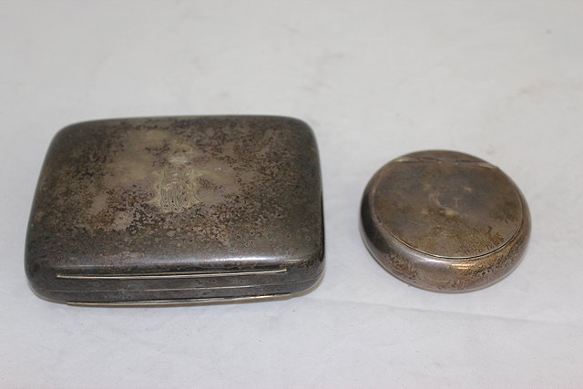 Appraisal: A CIRCULAR SILVER TOBACCO BOX the lid engraved with the