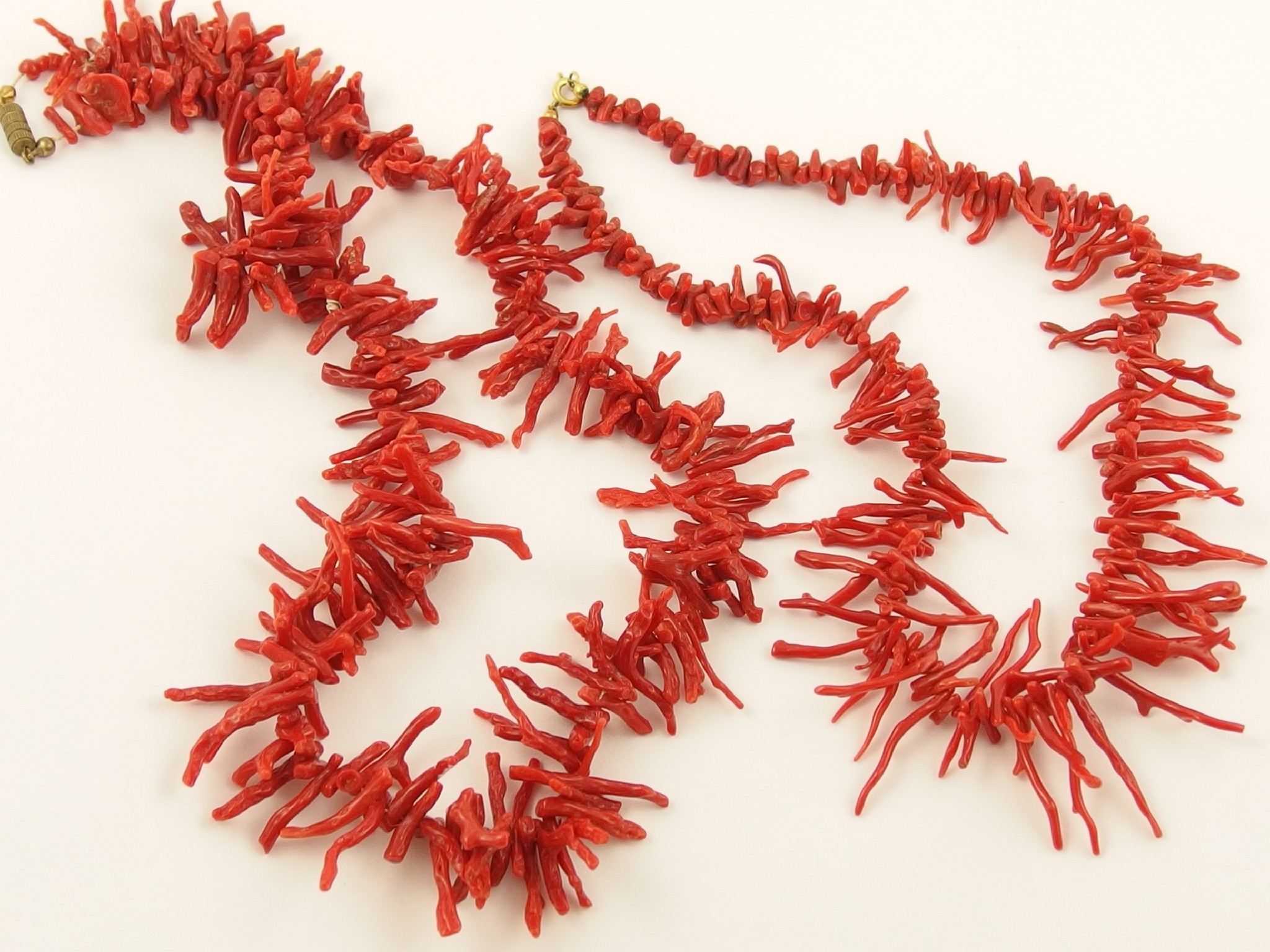 Appraisal: Two coral festoon necklaces