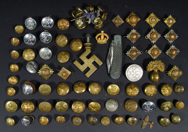 Appraisal: Collection of military buttons pips and cap badges a swastika