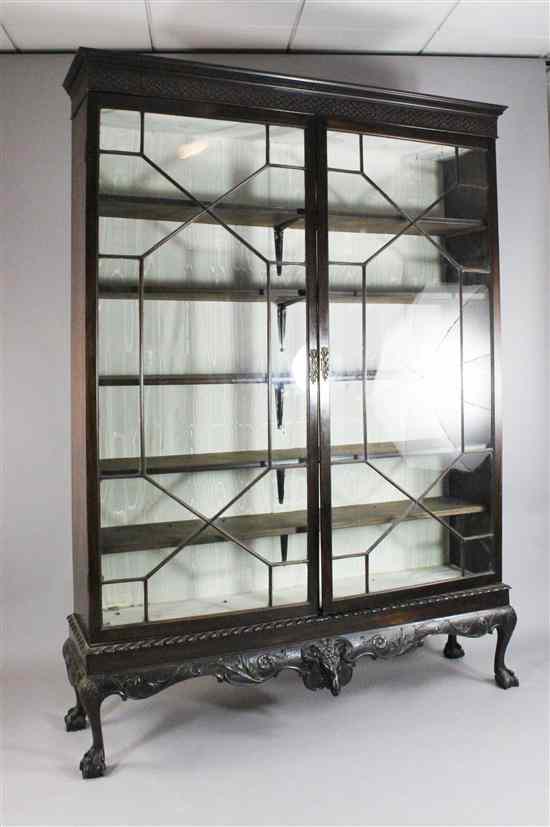 Appraisal: An Edwardian mahogany display cabinet with blind fret cornice above