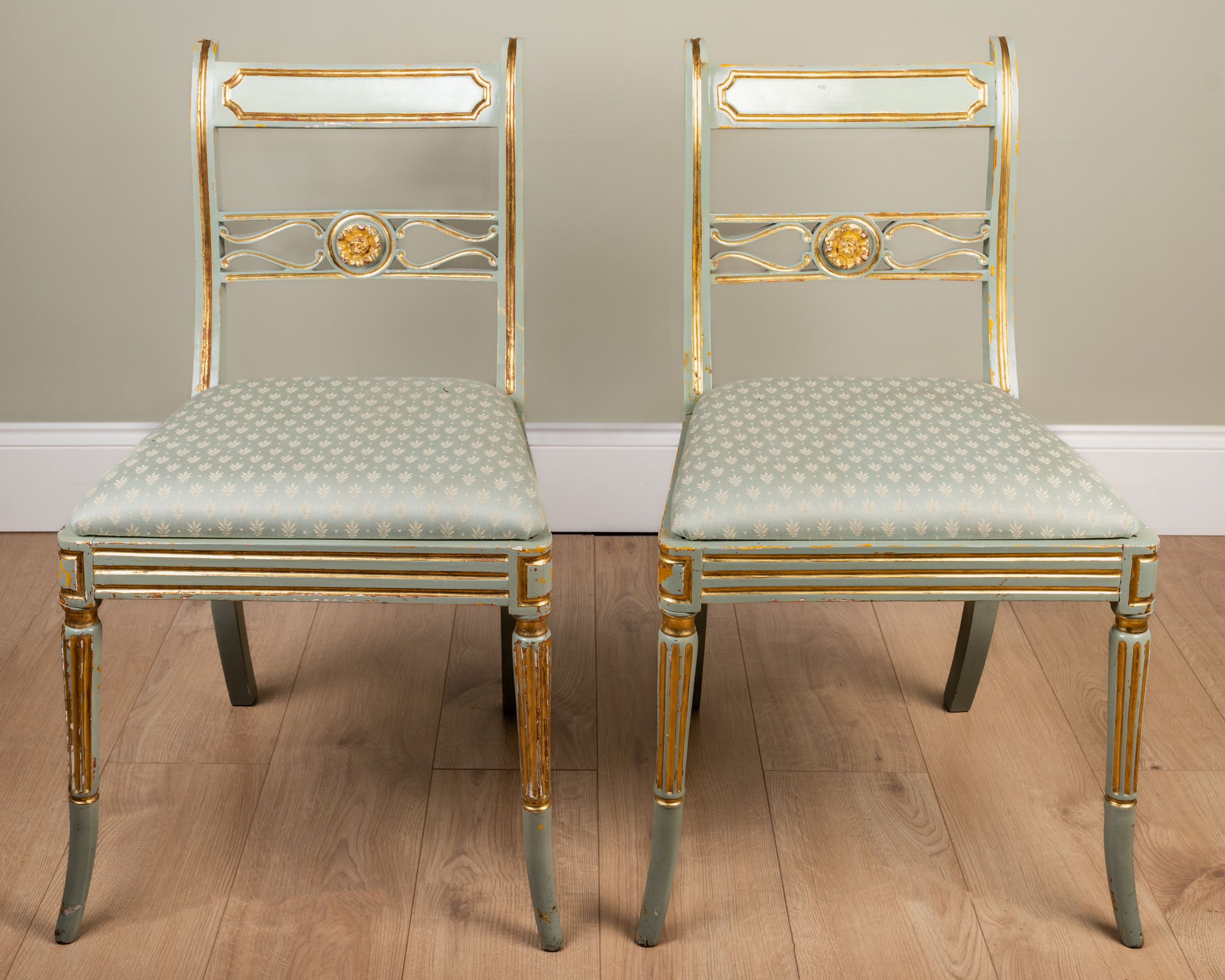 Appraisal: A pair of green painted and parcel-gilt side chairs with