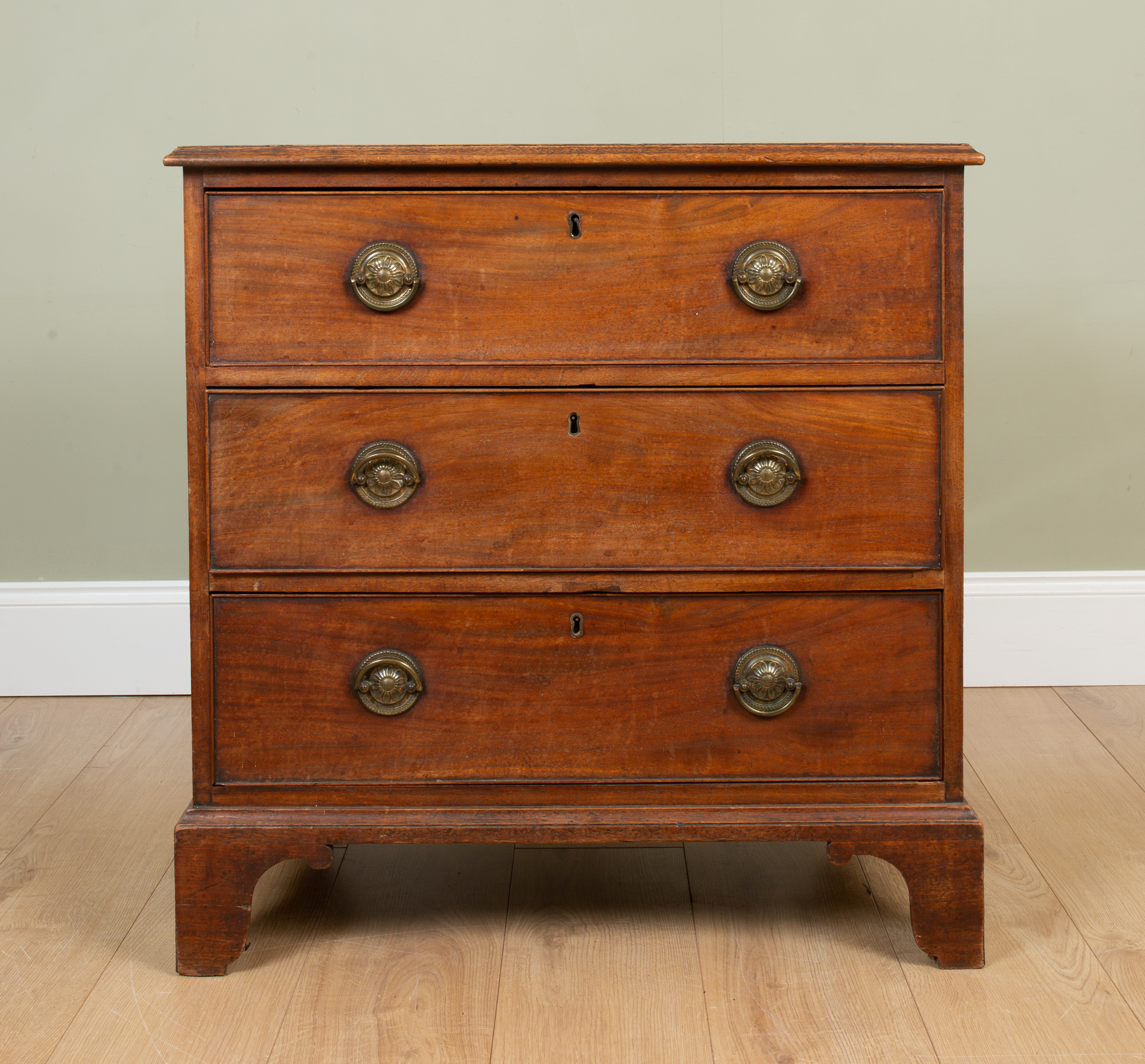 Appraisal: A George III mahogany Chippendale-style chest of three long drawers