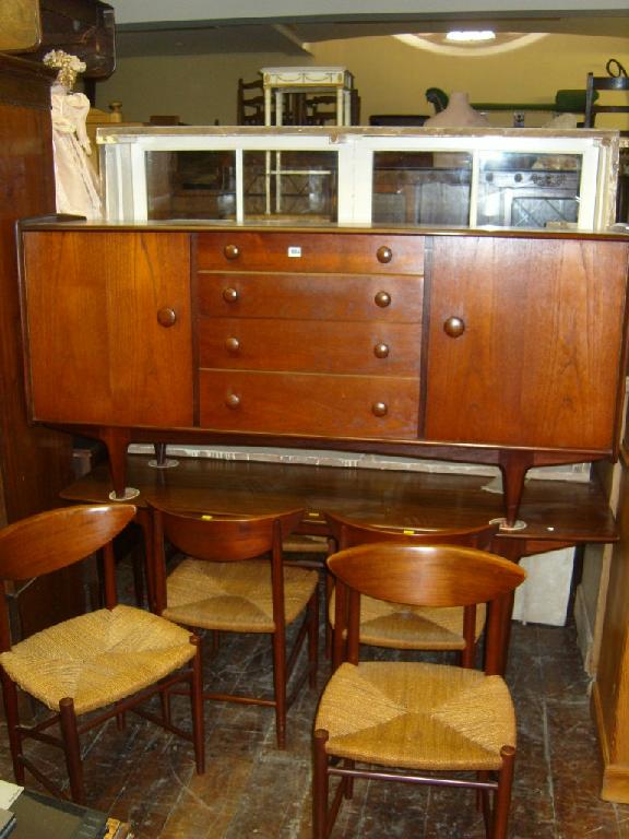 Appraisal: A modern teak wood dining room suite comprising table sideboard