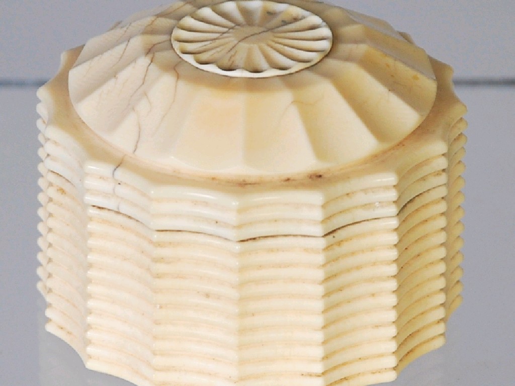 Appraisal: ORIENTAL CARVED IVORY CIRCULAR BOX with ribbed wavy side screw