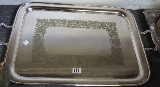 Appraisal: A plated rectangular twin handled tray with a central scroll