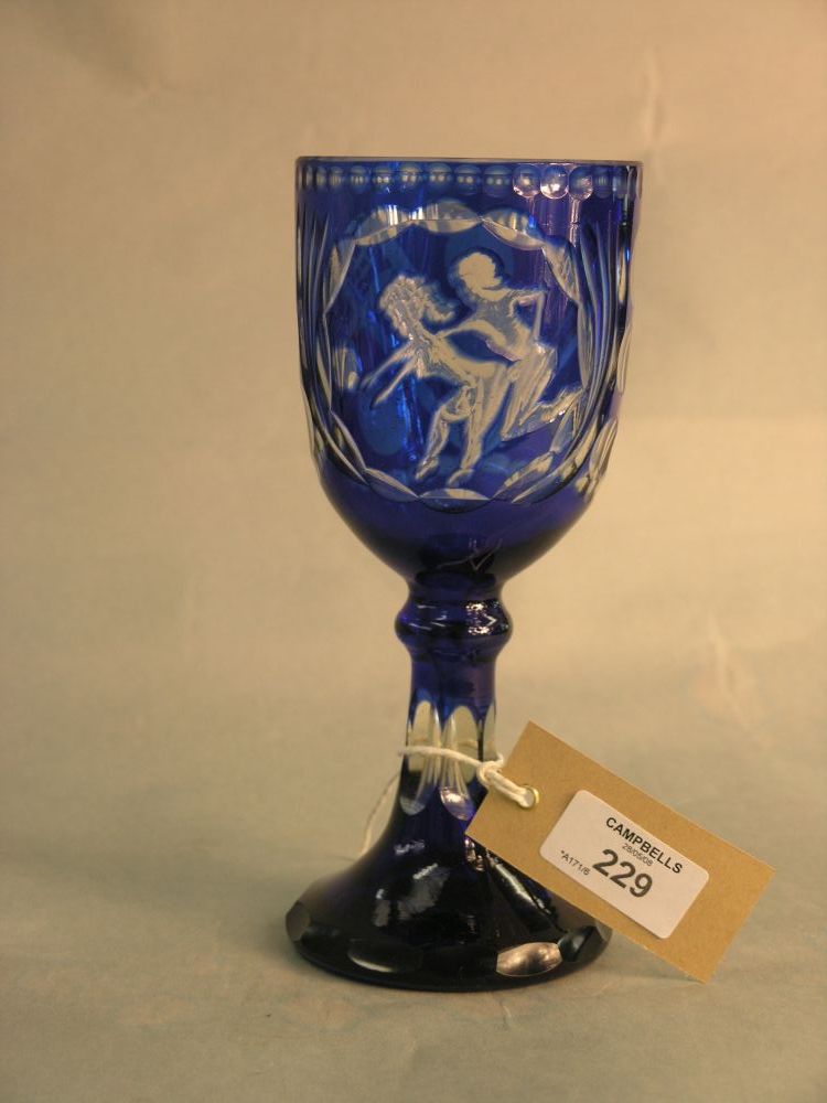 Appraisal: A late th Century blue overlaid glass goblet engraved with