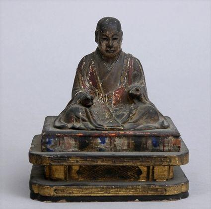 Appraisal: JAPANESE CARVED AND PAINTED SHRINE FIGURE The seated cloaked priest