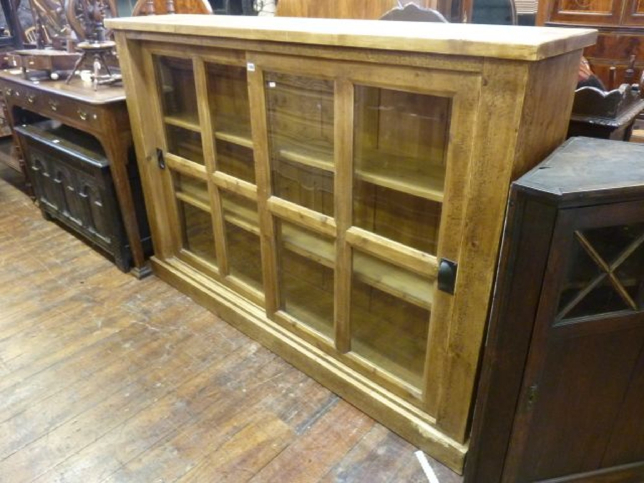 Appraisal: A reclaimed pine bookcase display cabinet enclosed by two glazed