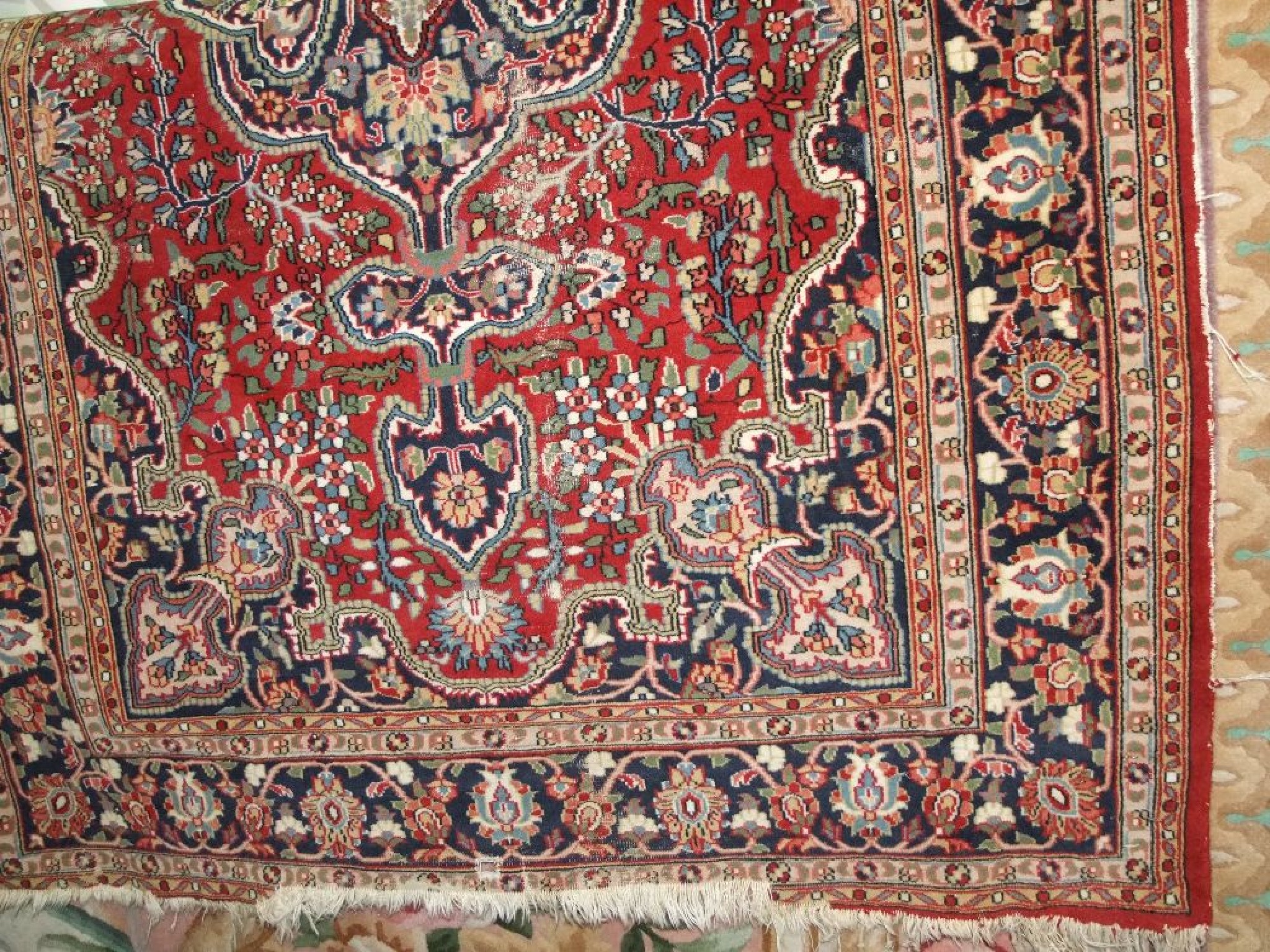 Appraisal: An eastern wool rug with red ground central medallion set