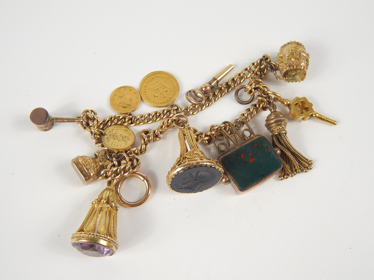 Appraisal: A ct gold hollow charm bracelet with a George III