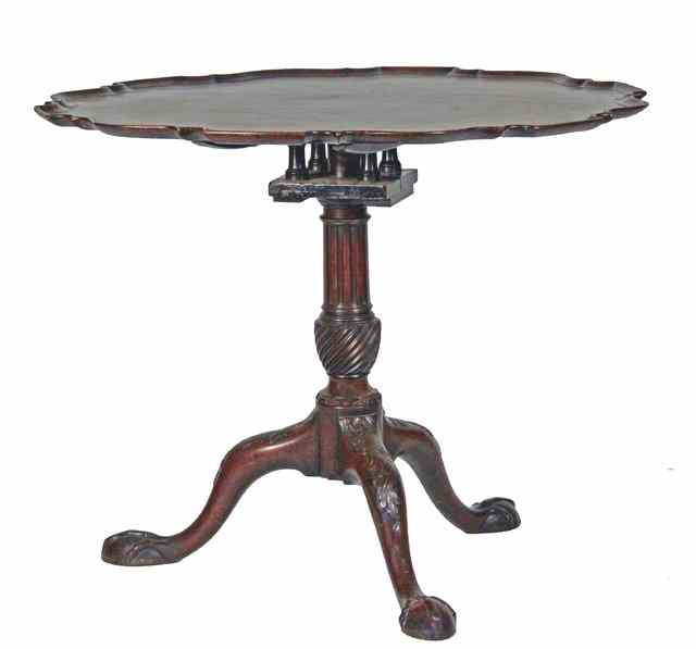 Appraisal: An th Century mahogany table with piecrust moulded border on