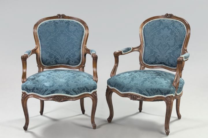 Appraisal: Pair of Provincial Louis XV-Style Fruitwood Fauteuils each with a