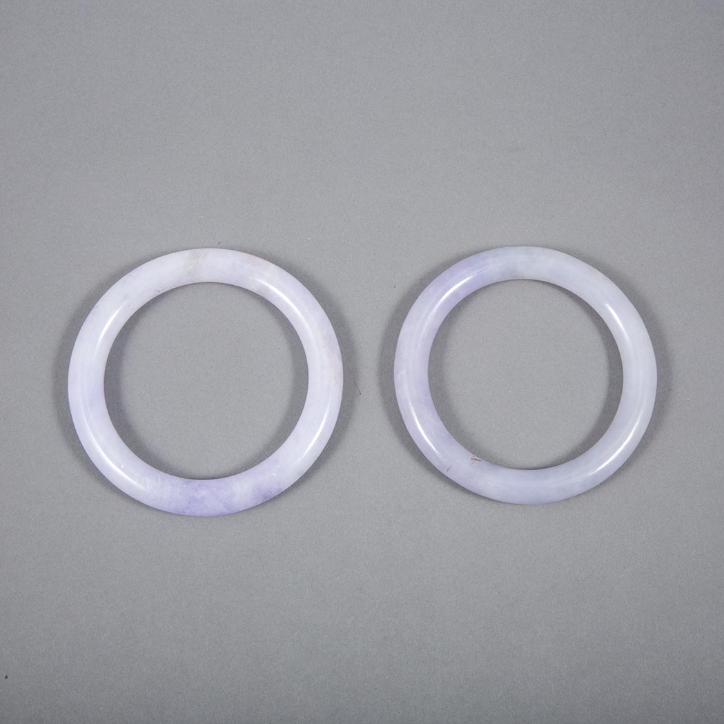 Appraisal: Two Similar Chinese Jadeite Bangles Each in lavender and celadon