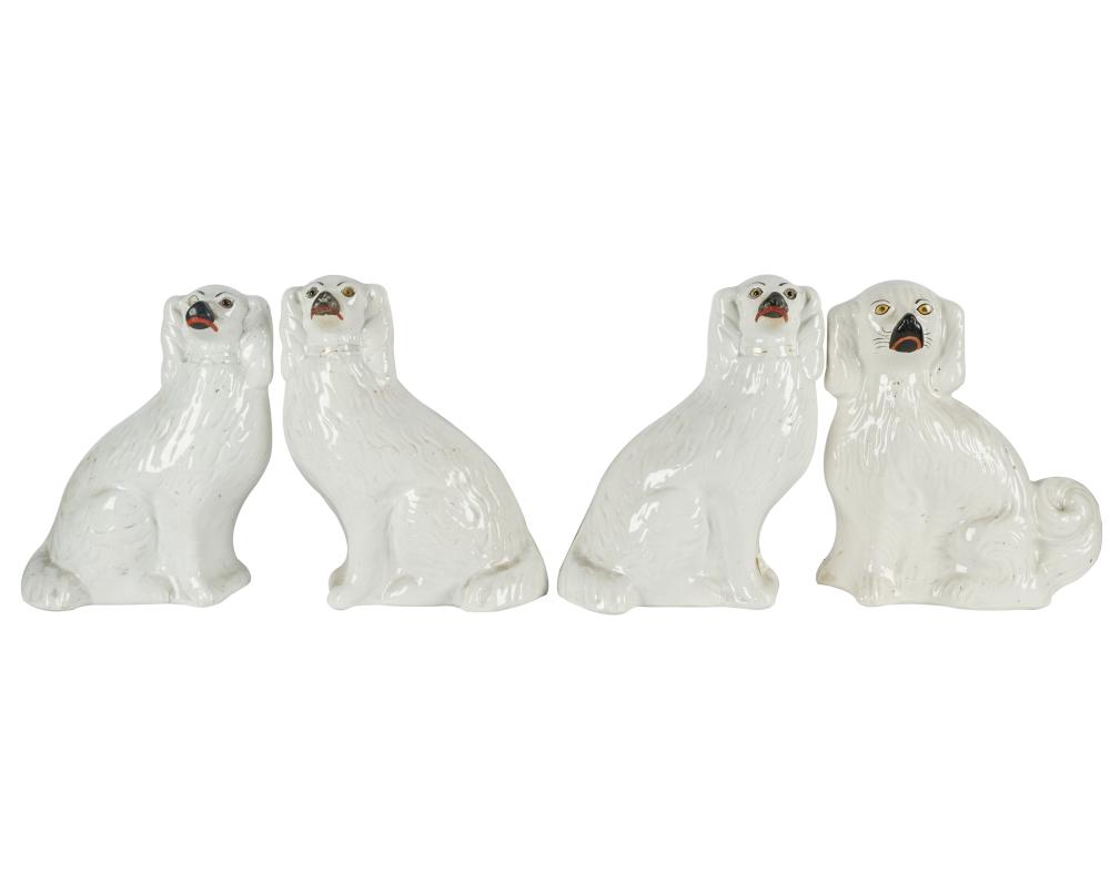 Appraisal: FOUR WHITE STAFFORDSHIRE POTTERY DOG FIGURESunmarked modeled as spaniels three