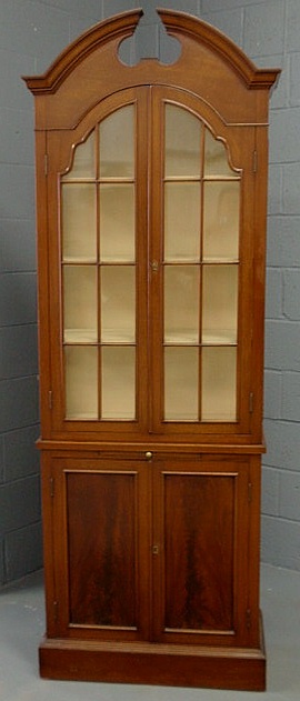 Appraisal: Hepplewhite style mahogany one-piece cabinet with a broken arch top