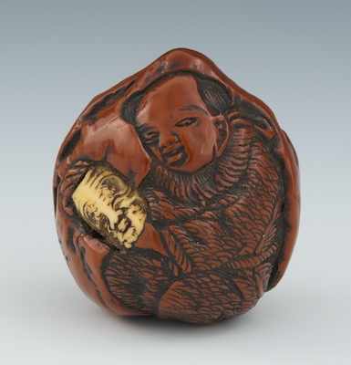 Appraisal: A Lacquered Peach Nut Netsuke Carved from a nut then