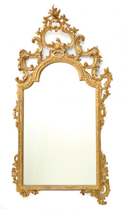 Appraisal: AN ELABORATE FOLIATE CARVED AND PIERCED GILTWOOD WALL MIRROR TH