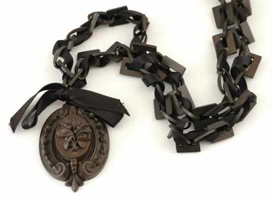 Appraisal: A Victorian bog oak locket and chain The locket of