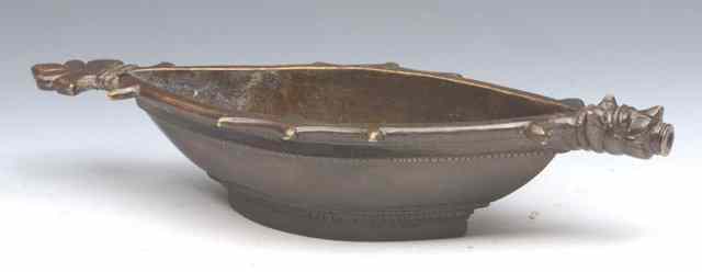 Appraisal: A PERSIAN BRONZE VESSEL of boat shaped form with figure