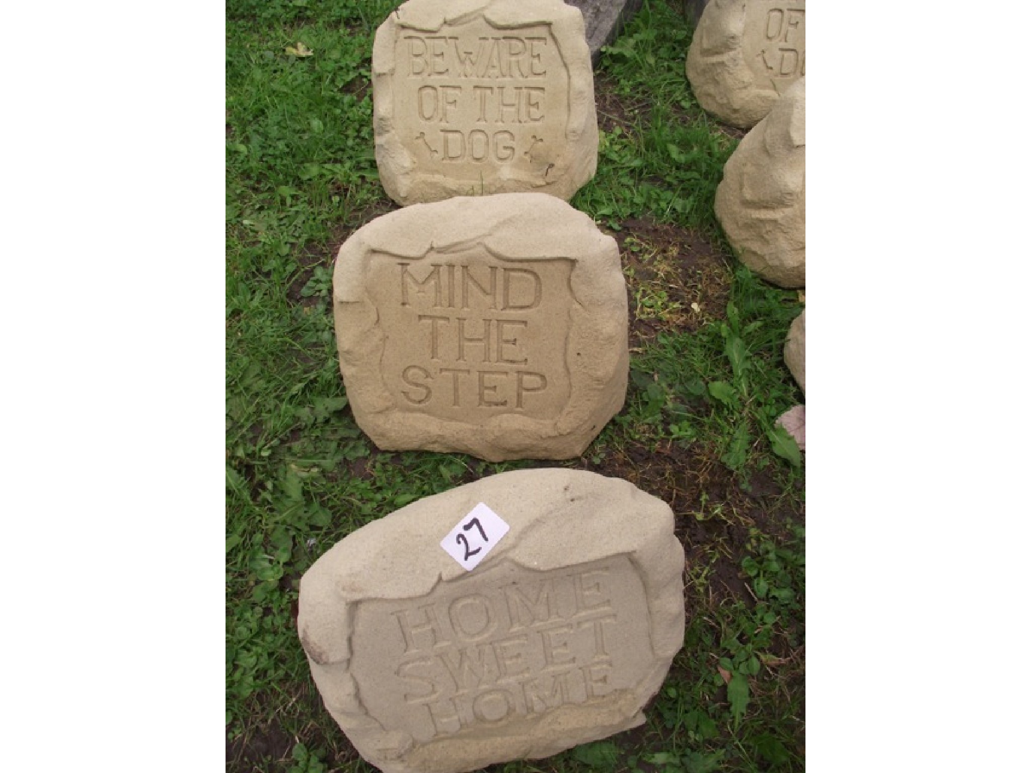 Appraisal: Three contemporary cast composition stone garden notices in the form