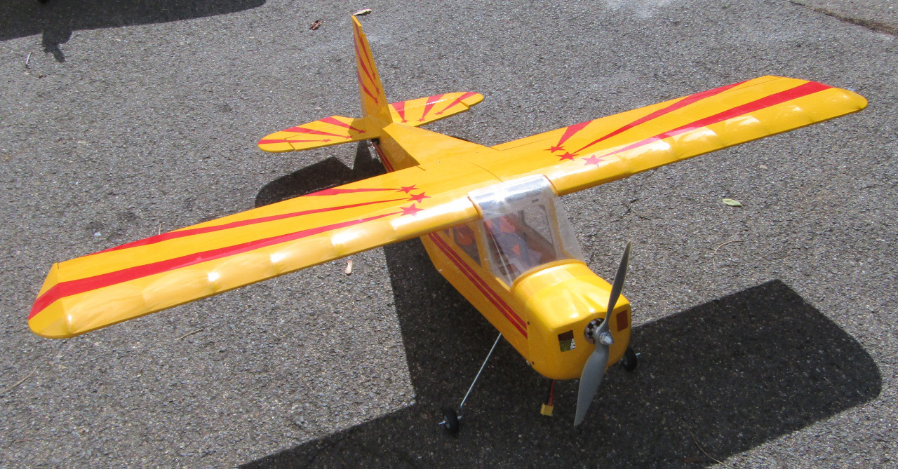 Appraisal: A remote controlled single propeller airplane in yellow with red