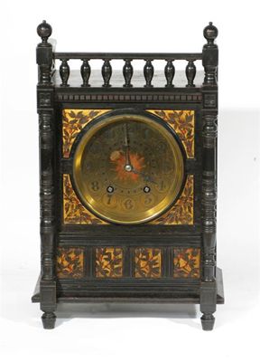 Appraisal: An Aesthetic Movement ebonised wood mantle clock the rectangular frame