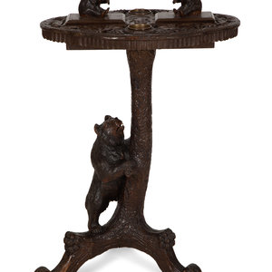 Appraisal: A Swiss Black Forest Carved Wood Smoking Table Early th