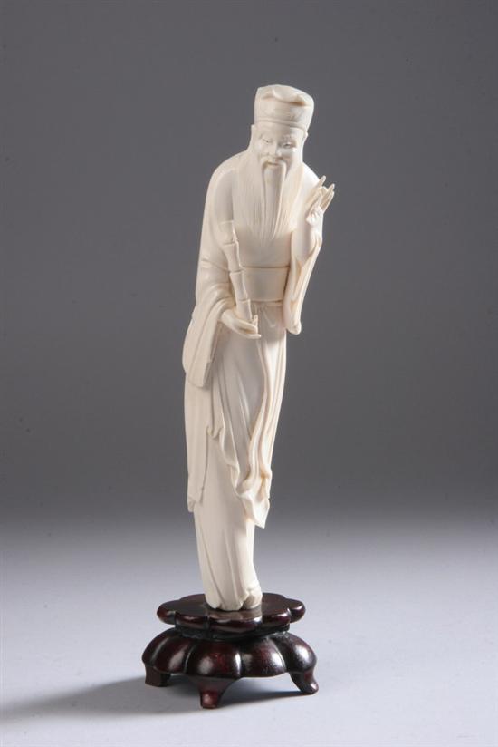 Appraisal: CHINESE IVORY FIGURE OF IMMORTAL Standing wearing long robes holding