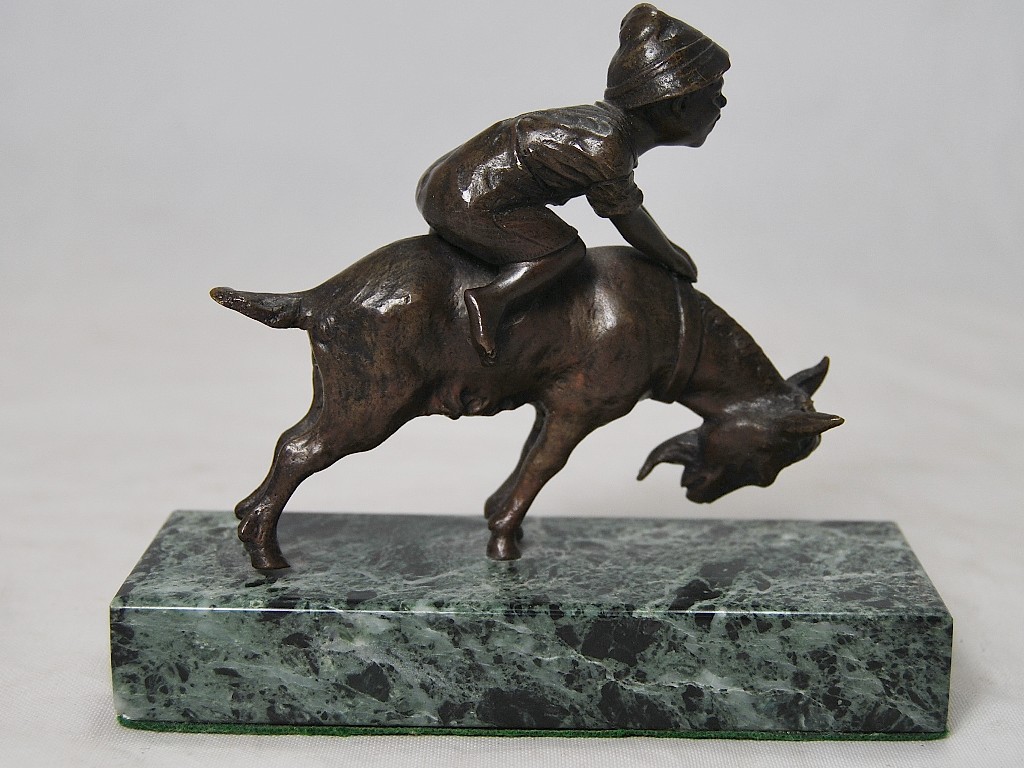 Appraisal: A small brown patinated bronze group of a child riding