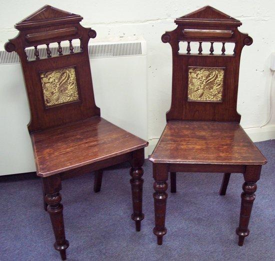 Appraisal: A pair of Victorian oak hall chairs the galleried backs