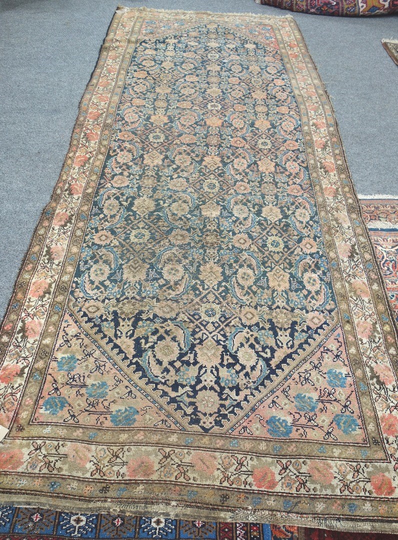 Appraisal: A West Persian runner the indigo field with an herate