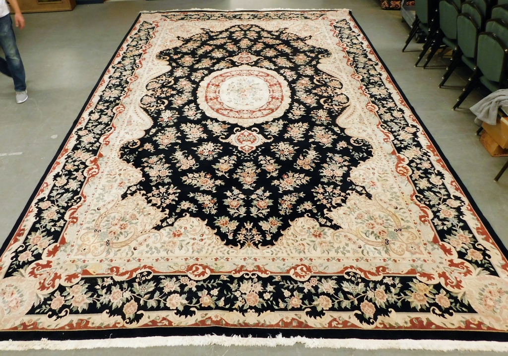 Appraisal: SEMI-ANTIQUE BLACK WHITE WOOL ORIENTAL CARPET Middle East th CenturyFloral