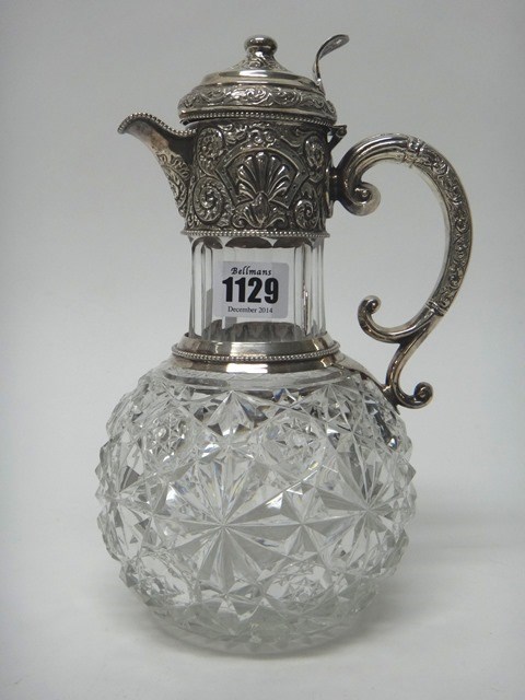 Appraisal: A Victorian silver mounted faceted glass hinge lidded claret jug