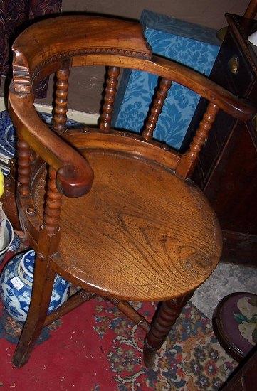 Appraisal: A Victorian elm seated elbow chair the back rest on