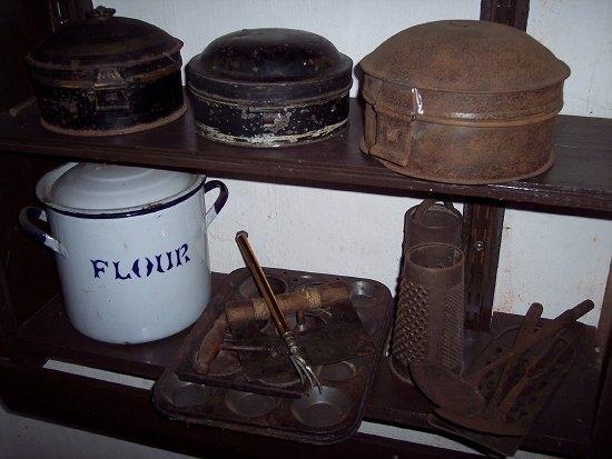 Appraisal: An enamel flour bin three tole spice containers and sundry