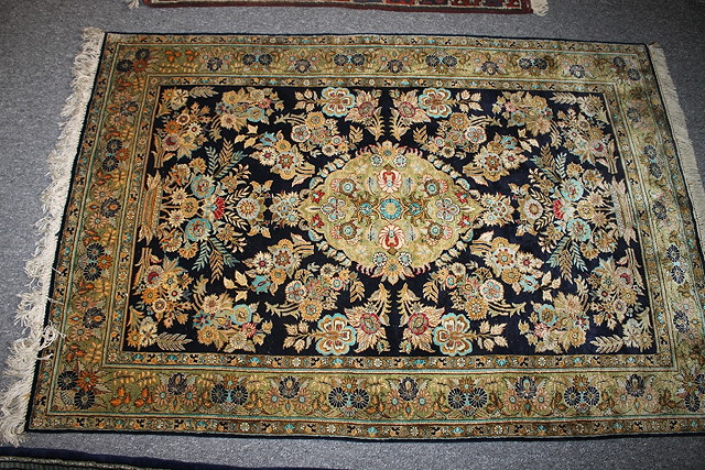 Appraisal: A KASHAN TYPE SILK RUG with central foliate medallion on