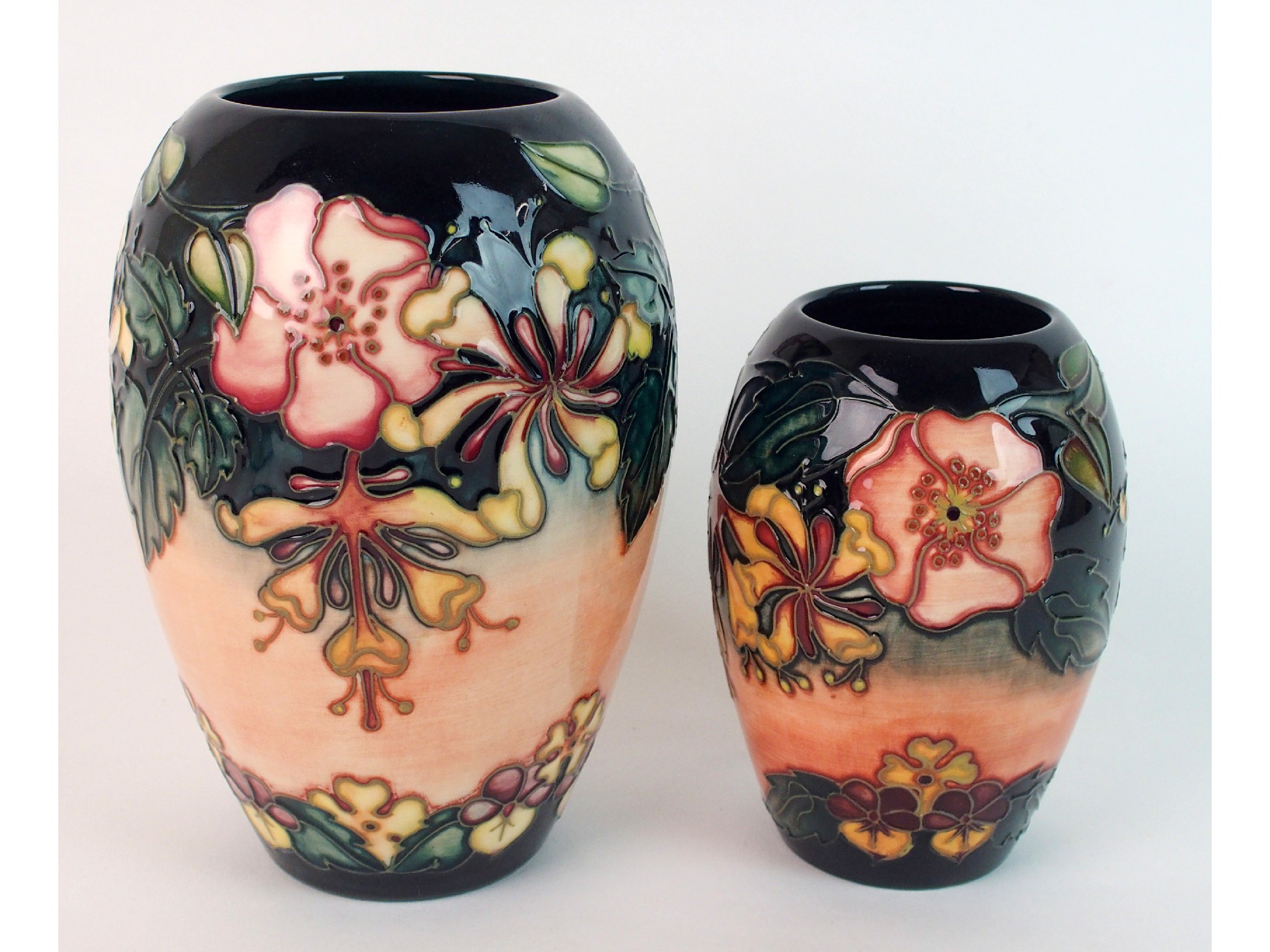 Appraisal: Two Moorcroft pottery Oberon vasesthe tubelined decoration of stylised flowers