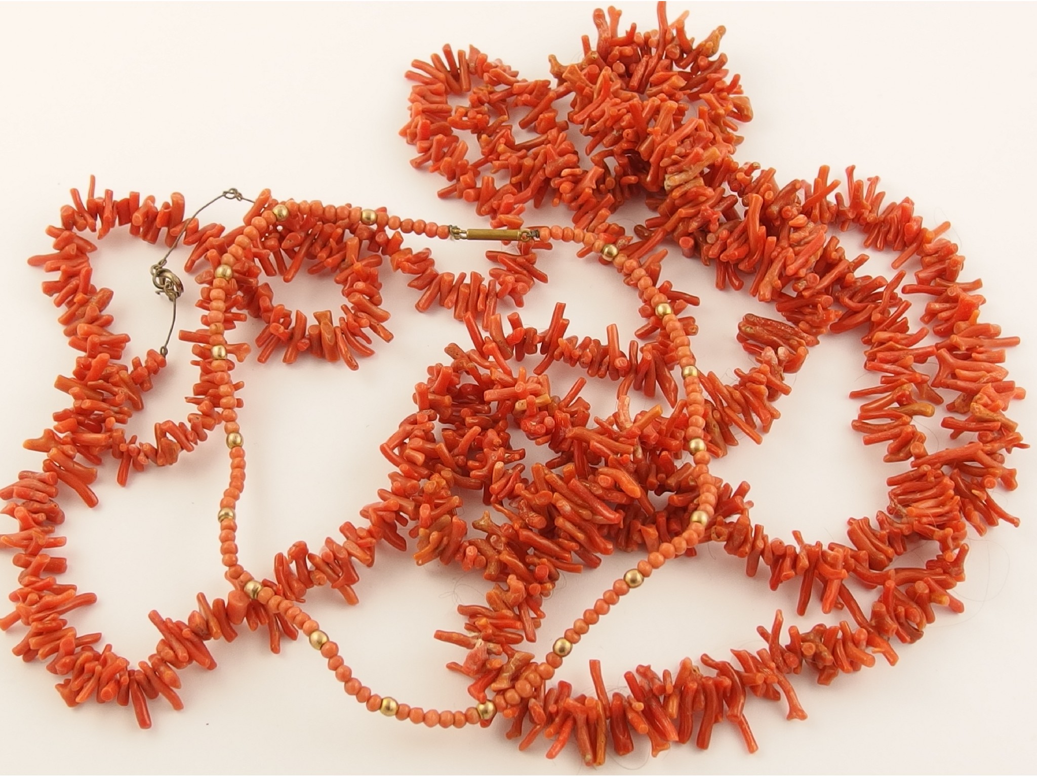 Appraisal: Two coral festoon necklaces and a round coral bead necklace