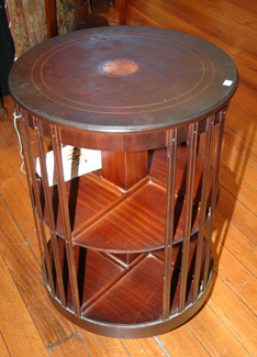 Appraisal: A SHERATON STYLE REVOLVING BOOK CABINET Circular marquetry inlaid top