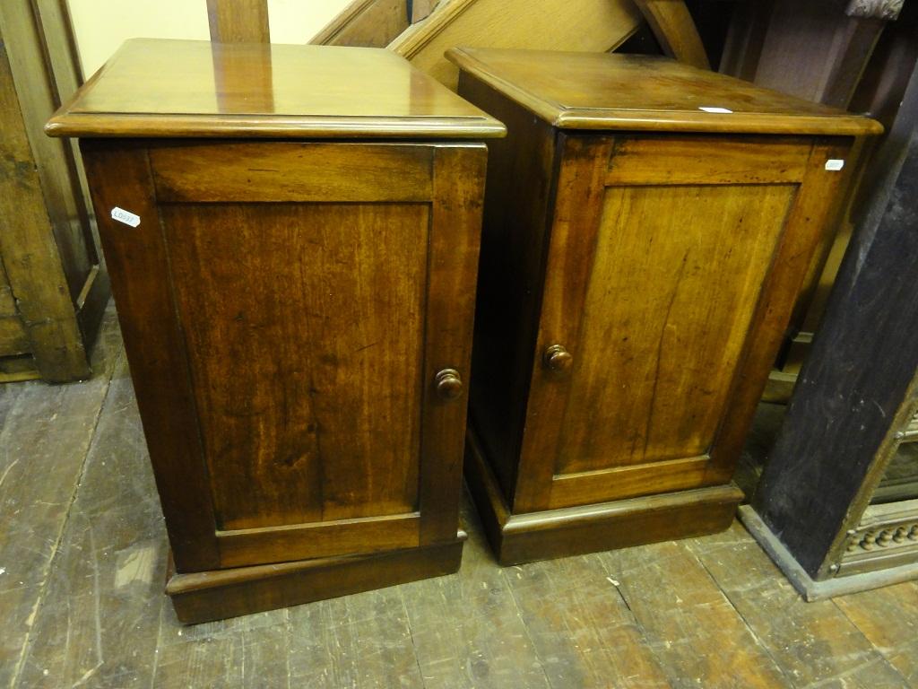 Appraisal: A pair of mahogany pedestal cupboards each enclosed by a